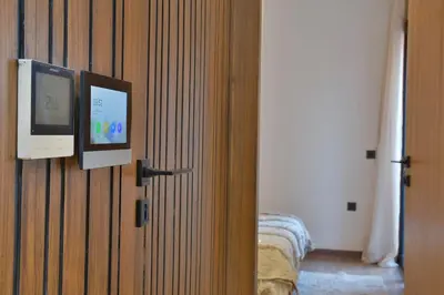 a door with a television and a bed in a room at Studio luxueux - centre ville in Marrakech