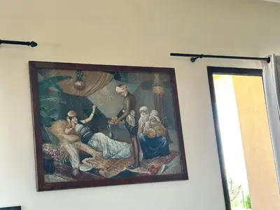 a painting hanging on a wall in a room at Villa l'odyssée in Marrakech