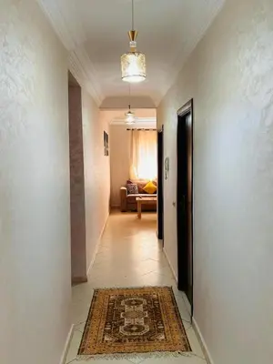 a hallway with a room with a couch and a rug at Quiet &Bright Apartment in Marrakech