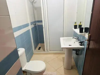 a bathroom with a toilet and a sink and a shower at Quiet &Bright Apartment in Marrakech