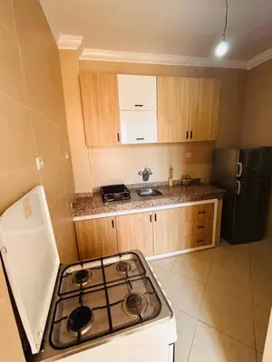 a kitchen with a stove top and a refrigerator at Quiet &Bright Apartment in Marrakech