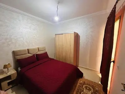 a bedroom with a red bed in a room at Quiet &Bright Apartment in Marrakech