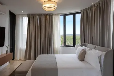 a bedroom with a white bed and a large window at Villa Montbel in Marrakech