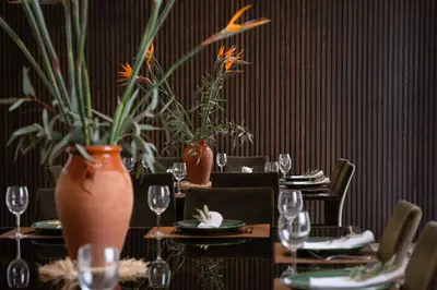 a table with plates and glasses and vases on it at Villa Montbel in Marrakech