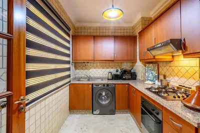 a kitchen with a washer and dryer in it at Perle Soft light and air conditioning in Marrakech