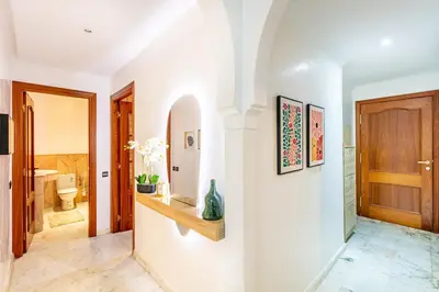 a hallway with a bathroom with a toilet and a door at Perle Soft light and air conditioning in Marrakech