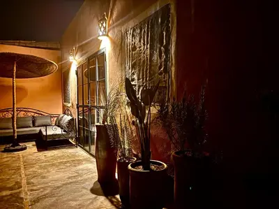 a living room with a couch and a potted plant at Villa Bellisa in Marrakech