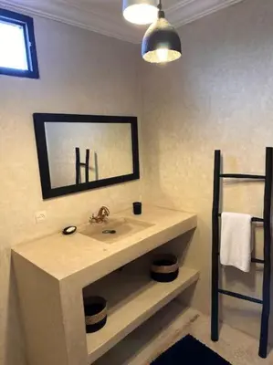a bathroom with a sink and a mirror at Villa Bellisa in Marrakech