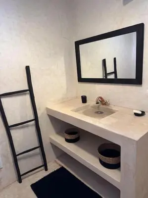 a bathroom with a sink and a mirror at Villa Bellisa in Marrakech