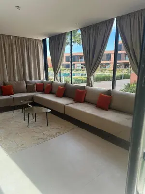 a large couch in a room with windows at Marrakech Peaceful Escape - Appartement Noria Marrakech in Marrakech