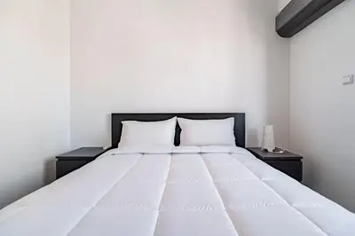 a large white bed with two pillows on it at Villa Djenna piscine privée sans vis-à-vis in Marrakech