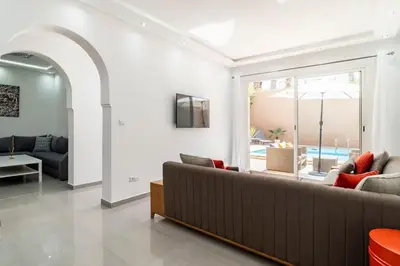 a living room with a couch and a table at Villa Djenna piscine privée sans vis-à-vis in Marrakech