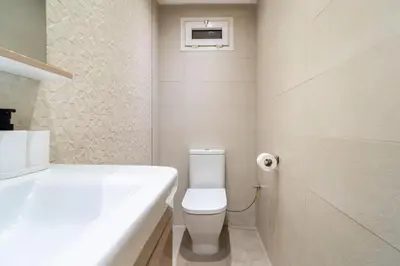 a white bathroom with a toilet and a sink at Villa Djenna piscine privée sans vis-à-vis in Marrakech