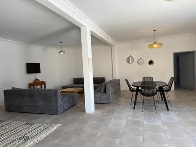 a living room with a table and a couch at Villa Lalla et Moulay in Marrakech