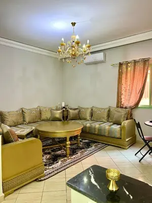 a living room with a couch and a table at Appartement allal el fassi in Marrakech