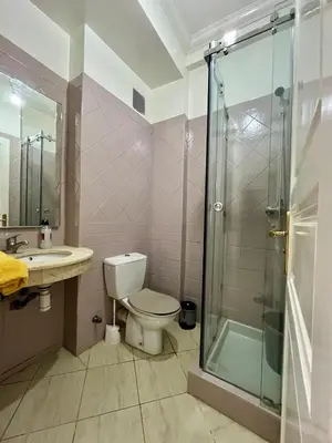 a bathroom with a toilet and a glass shower at Appartement allal el fassi in Marrakech