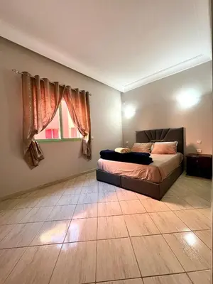 a bedroom with a bed and a window at Appartement allal el fassi in Marrakech