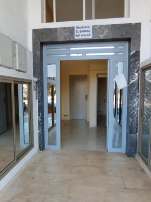 an entrance to a building with a glass door at Mhamid Appartement 3 chambres in Marrakech