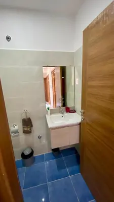 a bathroom with a sink and a mirror at Mhamid Appartement 3 chambres in Marrakech