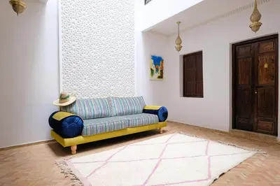 a living room with a couch and a door at Riad Armonia in Marrakech