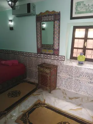 a room with a mirror on a tiled wall at Riad El yacout in Marrakech