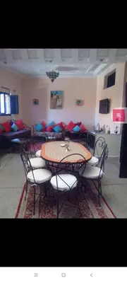 a table and chairs in a room with a table and chairs at Dar Hiba in Marrakech
