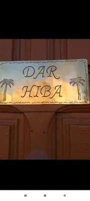 a birthday cake with palm trees on top of a cabinet at Dar Hiba in Marrakech