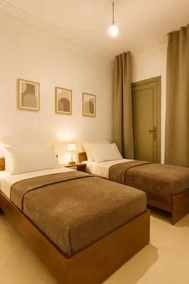 two beds in a hotel room with two beds at Marrakech Menara in Marrakech