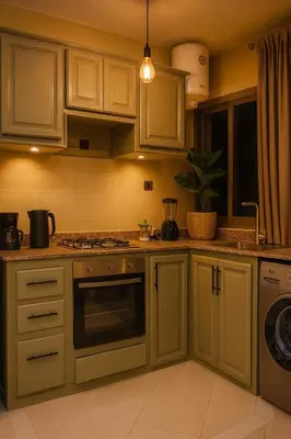 a kitchen with white cabinets and a stove top oven at Marrakech Menara in Marrakech
