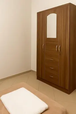 a bedroom with a wooden cabinet and a white rug at Marrakech Menara in Marrakech