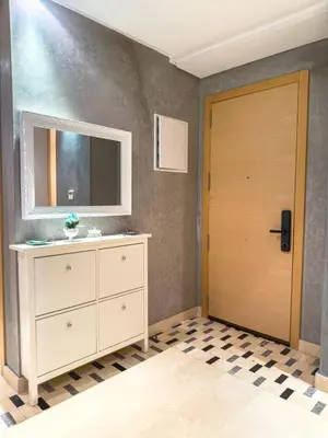 a bathroom with a dresser and a mirror and a door at VIVASTAY Marrakech - Prestigia Topaze- Terrace overlooking garden & pool in Marrakech