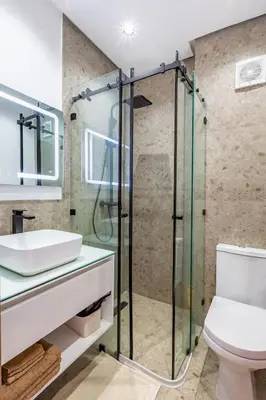 a bathroom with a glass shower and a toilet at Villa Gina, Piscine, Terasse, 15 min du centre in Marrakech