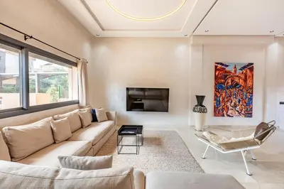a living room with a couch and a fireplace at Villa Gina, Piscine, Terasse, 15 min du centre in Marrakech