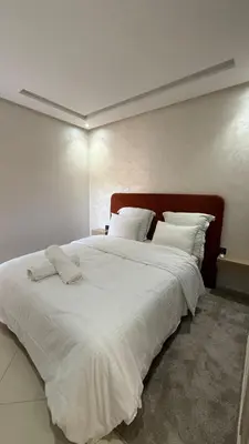 a large white bed with white sheets and pillows at Abir37 in Marrakech