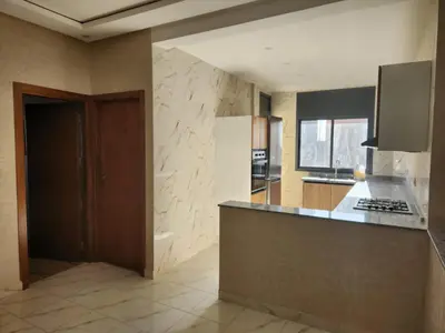 a kitchen with a counter and a stove top oven at Appartement Aéroport Holiday in Marrakech