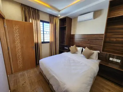 a bedroom with a large white bed in a room at Appartement Aéroport Holiday in Marrakech