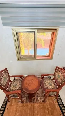 a room with a table and two chairs and a window at HiverLux in Marrakech