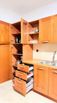 a kitchen with wooden cabinets and a sink at HiverLux in Marrakech