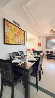 a dining room with a table and chairs at HiverLux in Marrakech