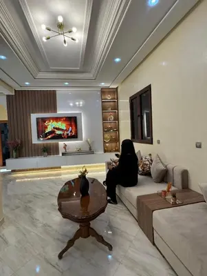 a living room with a couch and a table at Maison luxueuse méga spacieuse in Marrakech