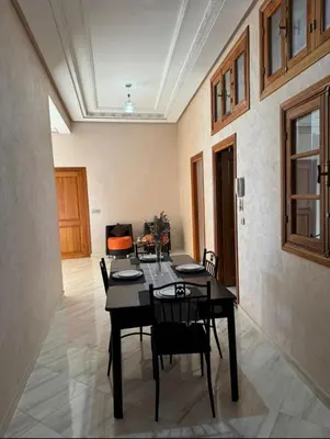 a dining room with a table and chairs at Maison luxueuse méga spacieuse in Marrakech