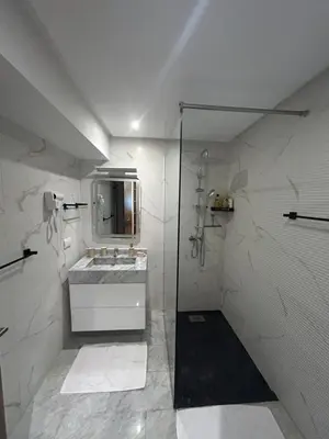 a white bathroom with a sink and a shower at Spacieux duplex 3 chambres - Piscine et parking in Marrakech