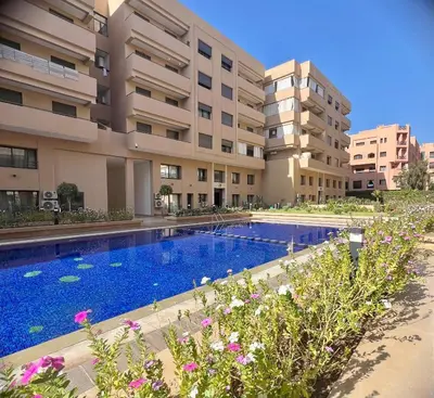 a swimming pool in front of a building at Spacieux duplex 3 chambres - Piscine et parking in Marrakech