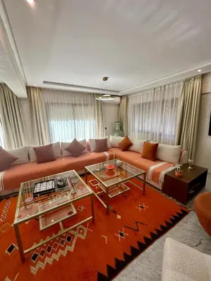 a living room with a large orange couch at Spacieux duplex 3 chambres - Piscine et parking in Marrakech