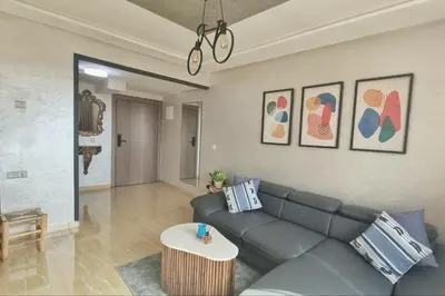 a living room with a couch and a table at Ilova 1 - Appartement Moderne au Centre de Marrakech in Marrakech