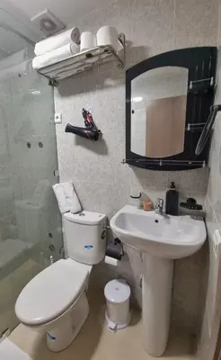 a bathroom with a toilet and a sink and a mirror at Ilova 1 - Appartement Moderne au Centre de Marrakech in Marrakech