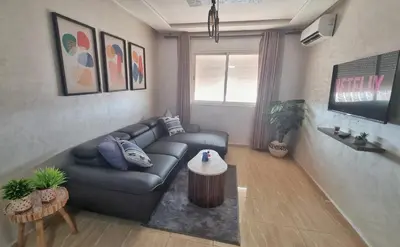 a living room with a couch and a table at Ilova 1 - Appartement Moderne au Centre de Marrakech in Marrakech
