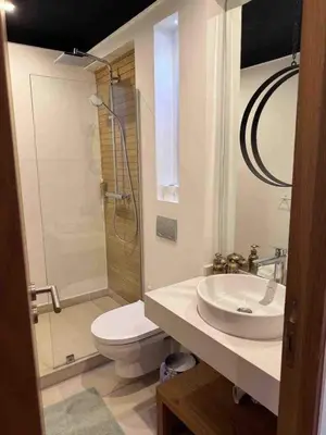 a bathroom with a toilet and a sink and a shower at Exceptional duplex apartment in Guéliz with Jacuzzi in Marrakech