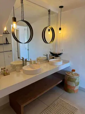 a bathroom with two sinks and a large mirror at Exceptional duplex apartment in Guéliz with Jacuzzi in Marrakech