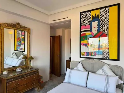 a bedroom with a mirror and a bed and a dresser at Exceptional duplex apartment in Guéliz with Jacuzzi in Marrakech